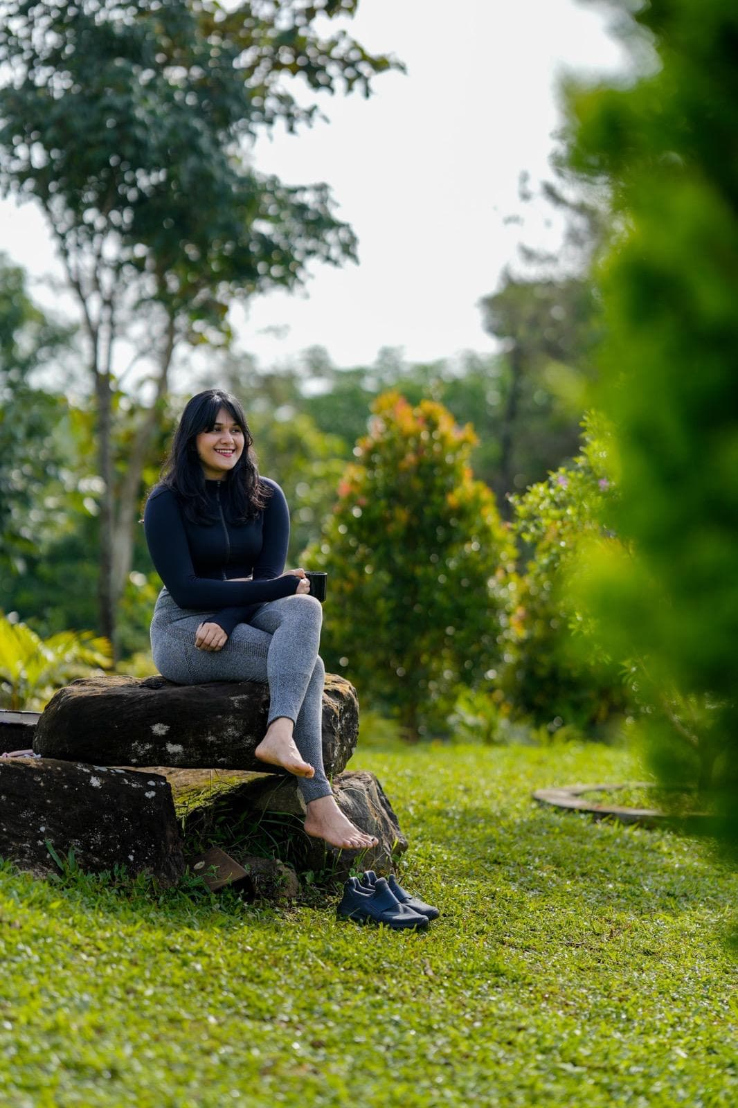 Sitting on a rock in a garden with a cup of coffee